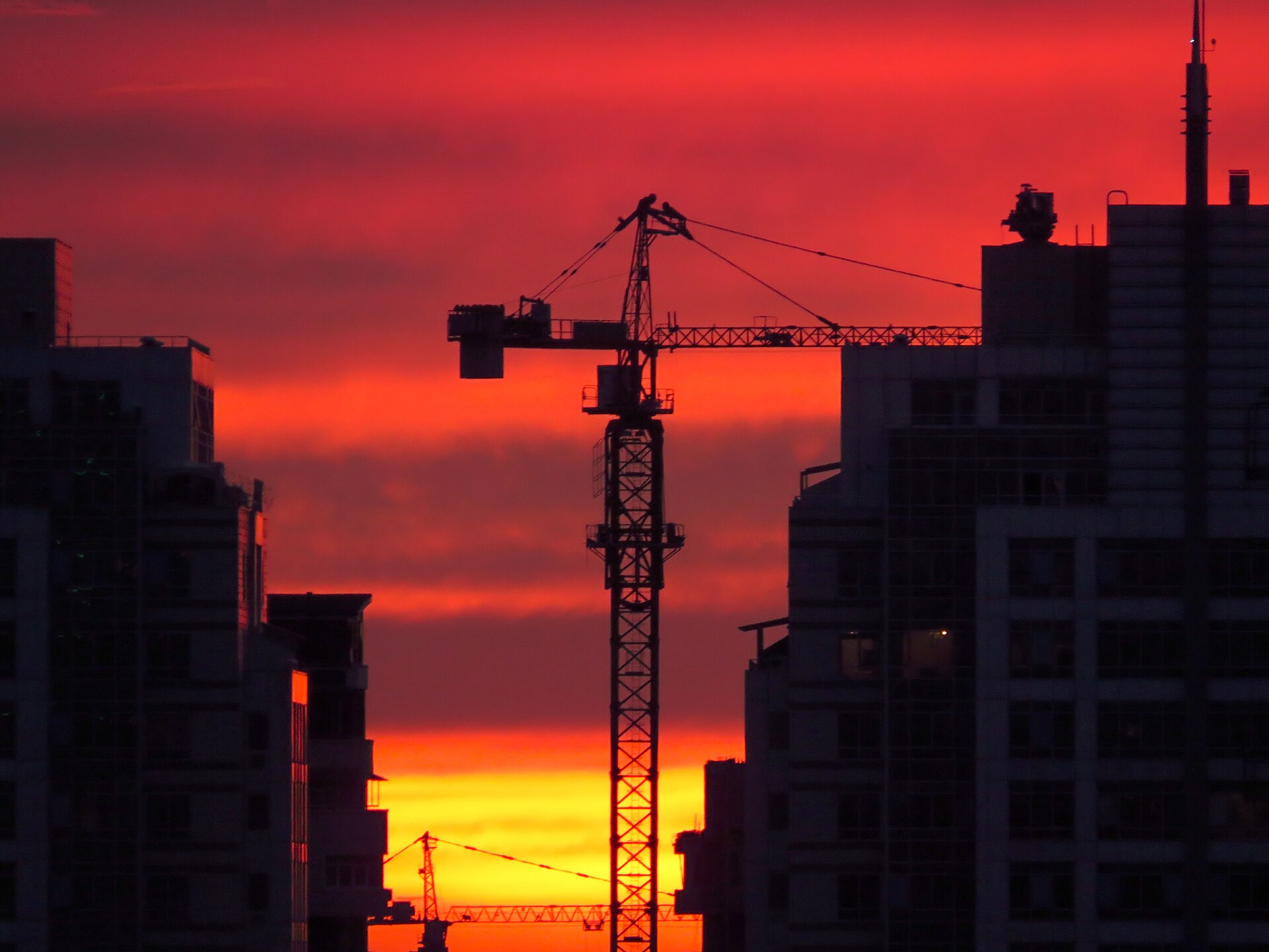 Construction crane silhouetted at dusk